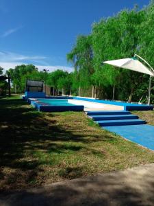 a row of blue steps with an umbrella at Aurora in Santiago del Estero