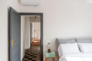 a bedroom with two beds and a blue door at Panoramic Stone Retreat - Menaggio by LoveComo in Menaggio