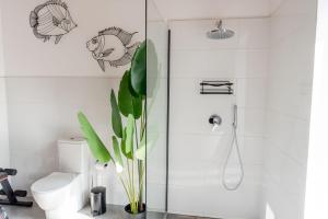 a bathroom with a toilet and a glass shower at Panoramic Stone Retreat - Menaggio by LoveComo in Menaggio +31 photos