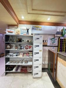 a shelf filled with lots of shoes in a room at فندق صفوة الجميزة in An Naqāʼ +31 photos