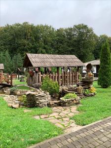 a garden with a gazebo in the grass at Orlyne Gnizdo in Chernivtsi +184 photos