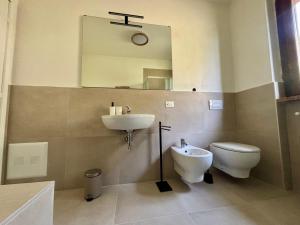 a bathroom with a sink and a toilet and a mirror at D'Annunzio in Gardone Riviera +12 photos