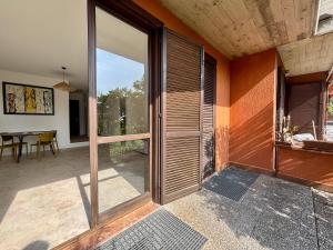 an open glass door of a house with a patio at D'Annunzio in Gardone Riviera
