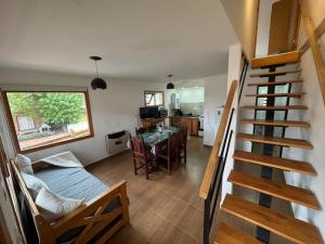 a room with a staircase leading to a living room at Las raíces departamentos in Ushuaia