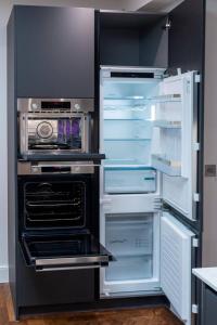 an open refrigerator with its door open in a kitchen at Luxury Seaside Home, Sleeps 6 in Broadstairs