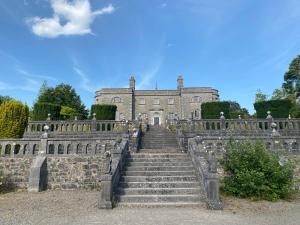 an old castle with stairs in front of it at Alpaca My Bags! at Andean Alpacas in Mullingar