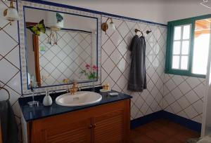 a bathroom with a sink and a mirror at Casa la Majada in Los Llanos de Aridane +67 photos