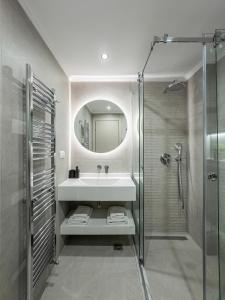a bathroom with a sink and a shower and a mirror at Bianco Mare Studios-Apartments in Kalives Poligirou +126 photos