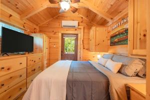 a bedroom with a large bed in a wooden cabin at Ryon Tiny Home Cabin City-side Rustic Retreat in Chattanooga