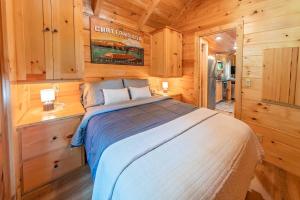 a bedroom with a bed in a wooden cabin at Ryon Tiny Home Cabin City-side Rustic Retreat in Chattanooga +22 photos