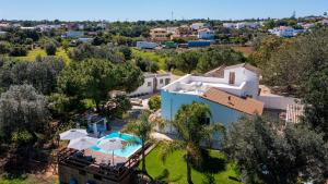 an aerial view of a house with a swimming pool at Spacious & Artistic House with Pool by HostWise in Moncarapacho
