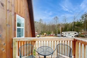 a deck with two chairs and a rv in a yard at Valley Vista Vacay 2 in Littleton