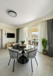 a living room with a black table and chairs at Bianco Mare Studios-Apartments in Kalives Poligirou