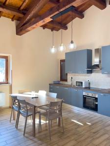 a kitchen with a table and chairs in a room at Casale Saporito in Montopoli in Sabina