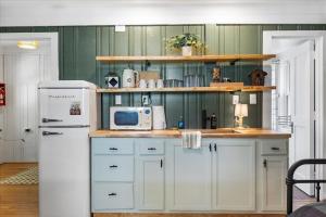a kitchen with white cabinets and a white refrigerator at 7- Rock Island Cottage in Lookout Mountain