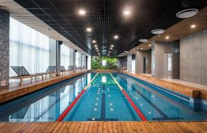a large swimming pool in a building at Kurzemes Pērle Beach Apartament - Albatross in Ķesterciems