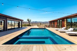 a swimming pool on the deck of a house at Iconic 7,000sf Glass Villa with 2 Pools on 350 Acres in Pioneertown