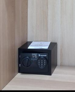 a small black microwave sitting on top of a table at B&B Central Station in Palermo