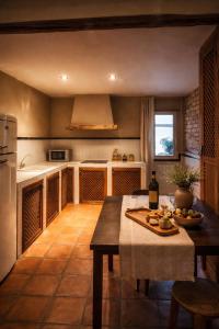 a kitchen with a table with a bottle of wine at La Posada De Lola in El Molar