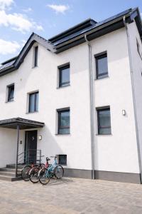 two bikes parked in front of a building at Apartment Heide in Soltau