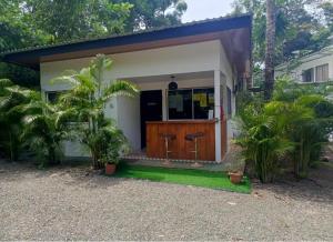 a small house with a front door and two chairs at Hotel Boutique D Angelo in Manzanillo