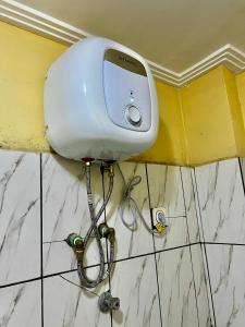 a hair dryer on the corner of a wall at NT Dreamhouse Cameroon in Zalom