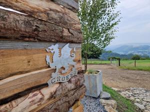 a sign on the side of a wooden building at Nyth - Nest Llangollen in Llangollen +6 photos