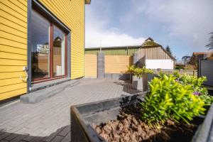 a yellow house with a patio in front of it at Haus Sonnengelb in Taarstedt