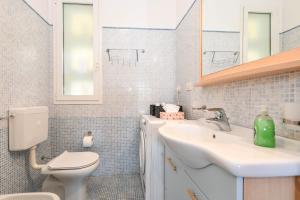 a bathroom with a sink and a toilet and a mirror at MGH- Lake Serenity Apartment in Padenghe sul Garda +30 photos