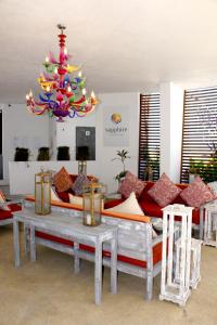 a living room with couches and a chandelier at Suites at Sapphire Ocean Club in Puerto Vallarta