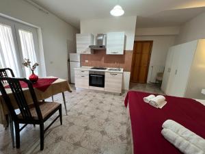 a kitchen with a table and a red table cloth on a room at Casa Latiini 1-2 in Pontinia +11 photos