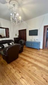 a living room with a couch and a television at Mate Guesthouse in Sighnaghi