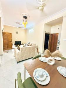a living room with a table and a couch at Elite Apartment in Hyderabad