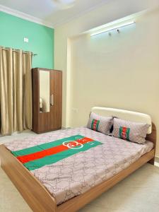 a bedroom with a bed with a olympics blanket on it at Elite Apartment in Hyderabad