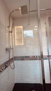 a bathroom with a shower with a glass door at Courtyard Apartament in Ballymore +33 photos