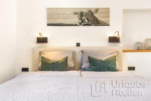 a bedroom with a bed with a picture of a cow at Ferienwohnung Antretter **** in Neubeuern