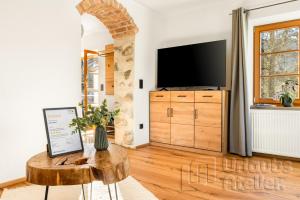 a living room with a tv and a table at Ferienwohnung Antretter **** in Neubeuern