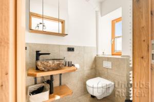 a bathroom with a toilet and a sink at Ferienwohnung Antretter **** in Neubeuern +31 photos