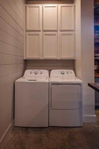 two white appliances sitting next to each other in a kitchen at The Frothy Flat- A Bunny Slippers Optional Destination in Chattanooga