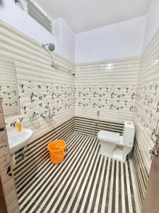 a bathroom with a black and white striped floor at Elite Apartment in Hyderabad