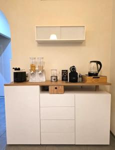 a kitchen with white cabinets and a counter top at Al Piccolo Cassaro in Caltanissetta