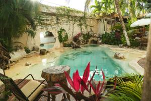 ein Swimmingpool in einem Hof mit Bäumen und Pflanzen in der Unterkunft Mezcal Boutique Hotel in Cancún