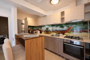 a kitchen with a sink and a stove at Salvatore Apartment #BucharestAirport in Ştefăneştii de Sus
