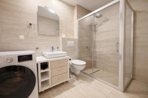 a bathroom with a shower and a toilet and a sink at Salvatore Apartment #BucharestAirport in Ştefăneştii de Sus