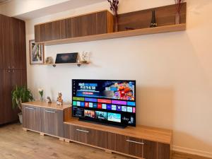 a living room with a flat screen tv on a wall at Salvatore Apartment #BucharestAirport in Ştefăneştii de Sus