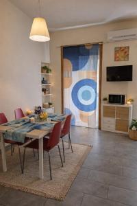 a dining room with a table and red chairs at Al Piccolo Cassaro in Caltanissetta
