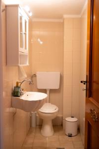 a bathroom with a white toilet and a sink at Central Boutique Apartment Gythio in Gythio +9 photos