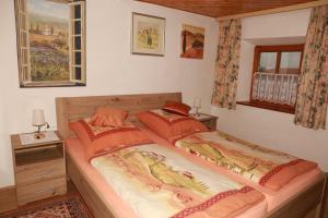 a bedroom with a large bed with orange pillows at Ferienhaus Stockmeier in Otting