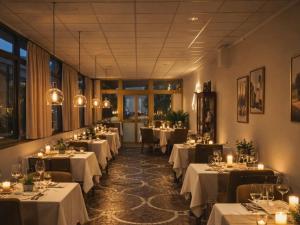 a dining room with tables with white tablecloths at Hotel Bottaccio in Frascati