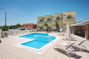 a resort with a swimming pool and chairs and a building at Sidari Vibes Aparthotel in Sidari